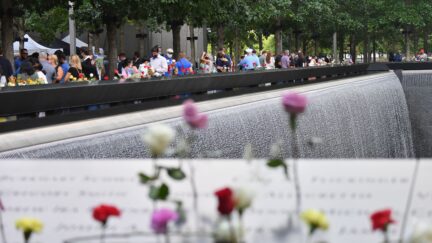 People gather at the 9/11 Memorial & Museum in New York on September 11, 2020, as the US commemorates the 19th anniversary of the 9/11 attacks. (Photo by Angela Weiss / AFP) (Photo by ANGELA WEISS/AFP via Getty Images)