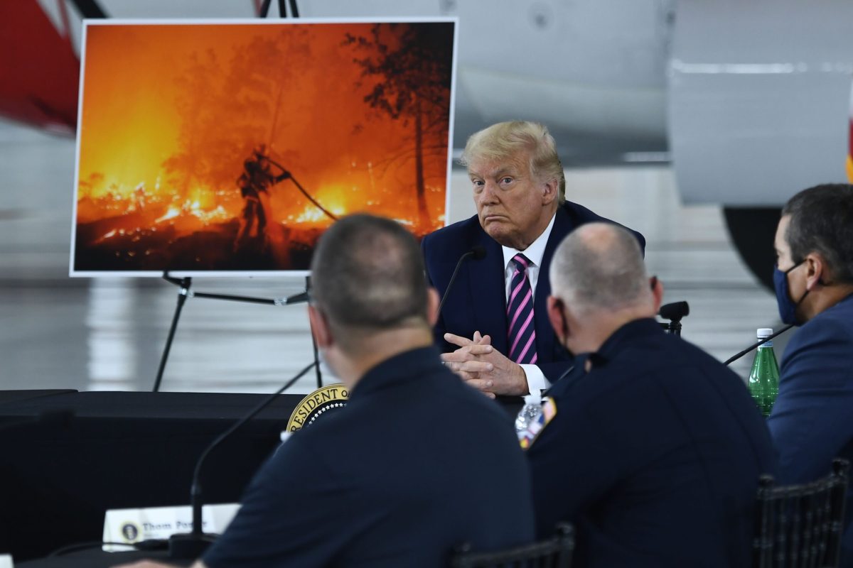 US President Donald Trump(C) listens to California Governor Gavin Newsom(D-CA) at Sacramento McClellan Airport in McClellan Park, California on September 14, 2020 during a briefing on wildfires. (Photo by Brendan Smialowski / AFP) (Photo by BRENDAN SMIALOWSKI/AFP via Getty Images)