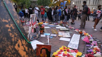 People visit a memorial for Breonna Taylor killed by Louisville Metro Police Officers earlier this year