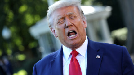Donald Trump yells with his eyes closed.
