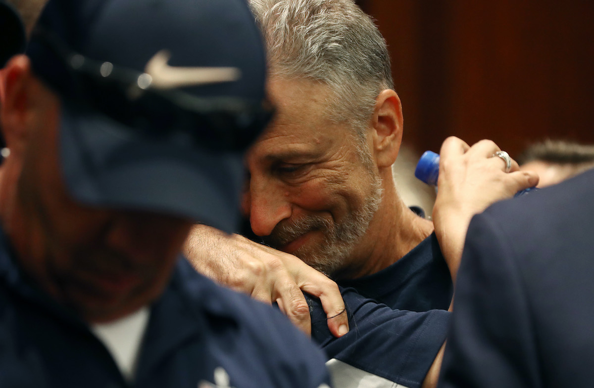Jon Stewart gets a hug after the U.S. Senate voted to renew permanent authorization of September 11th Victim Compensation Fund