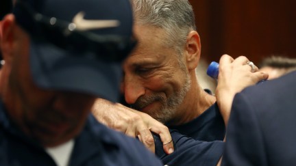 Jon Stewart gets a hug after the U.S. Senate voted to renew permanent authorization of September 11th Victim Compensation Fund