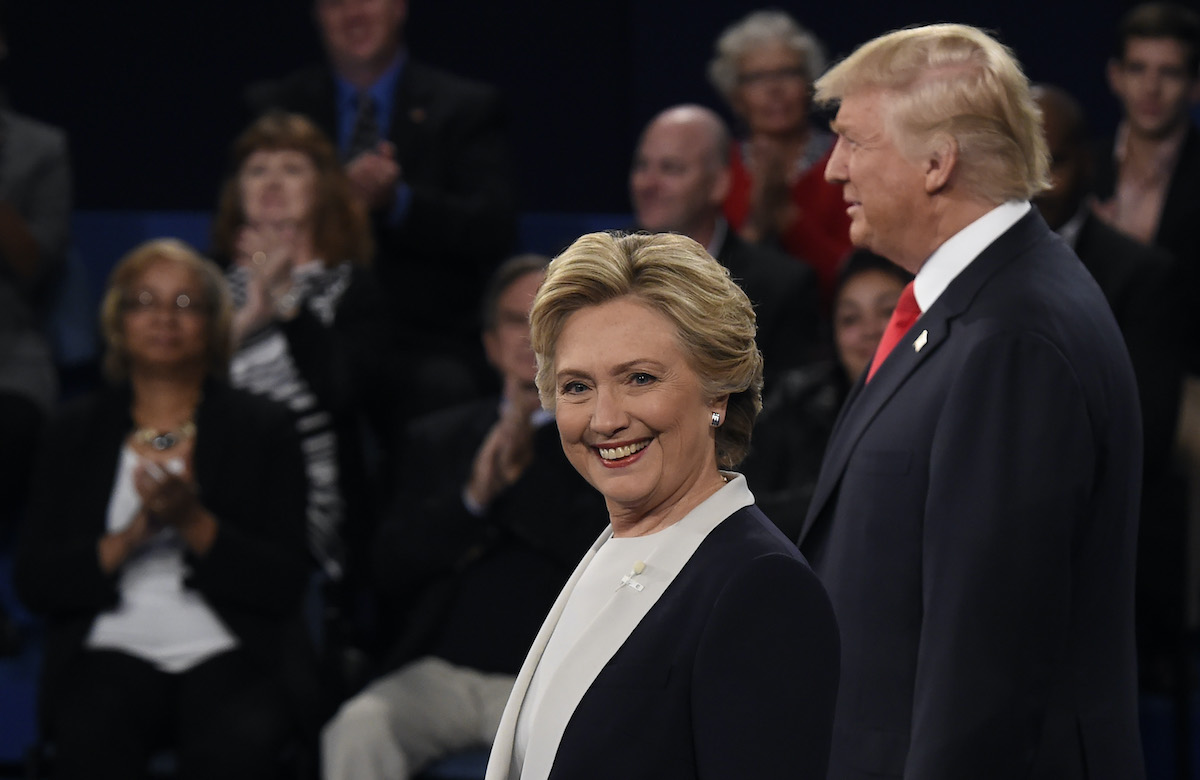 Democratic nominee Hillary Clinton (L) and Republican nominee Donald Trump stand in front of the audience during the second presidential debate in 2016.