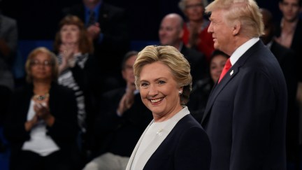 Democratic nominee Hillary Clinton (L) and Republican nominee Donald Trump stand in front of the audience during the second presidential debate in 2016.