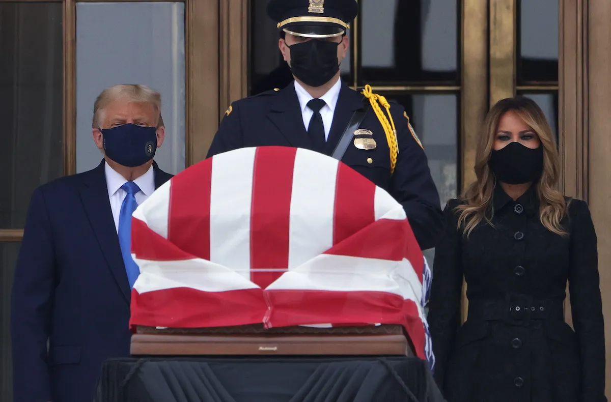Donald and Melania Trump stand behind Ruth Bader Ginsburg's flag-draped casket.