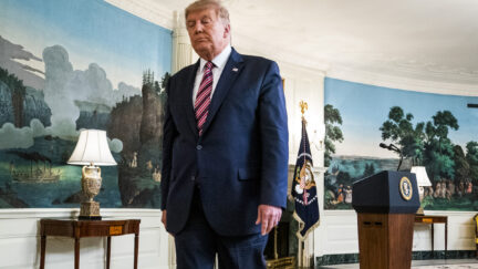 Donald Trump walks through the Diplomatic Reception Room of the White House