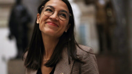 U.S. Rep. Alexandria Ocasio-Cortez smiles.