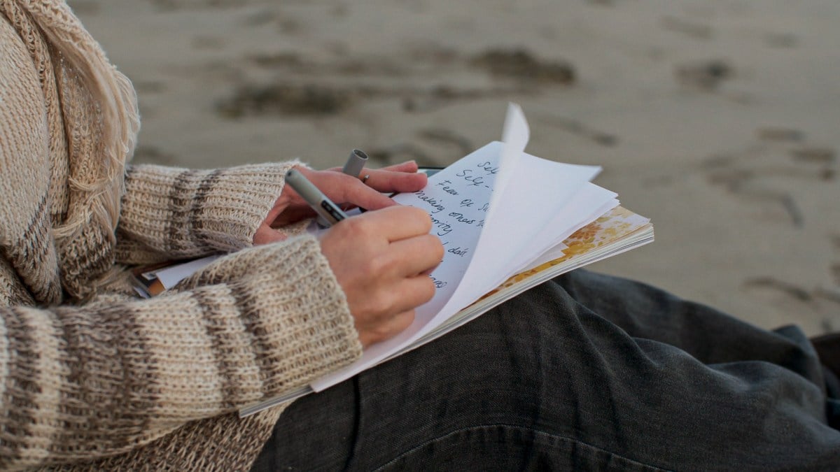 Still of a woman writing in a jorunal from HBO's The Vow