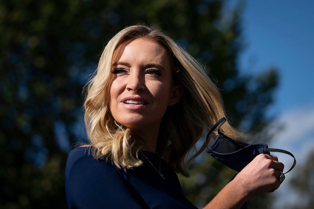 White House Press Secretary Kayleigh McEnany takes off her face covering before speaking with reporters outside the West Wing of the White House