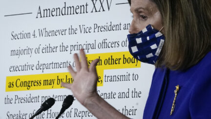 Nancy Pelosi (D-CA) speaks during a news conference at the U.S. Capitol in front of a blow-up of the text of the 25th amendment.