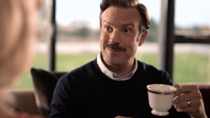 Ted Lasso holds a cup of tea.