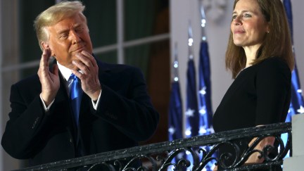 Donald Trump applauds Amy Coney Barrett on the White House balcony.