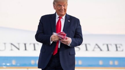 Donald Trump holds masks in front of Air Force One.