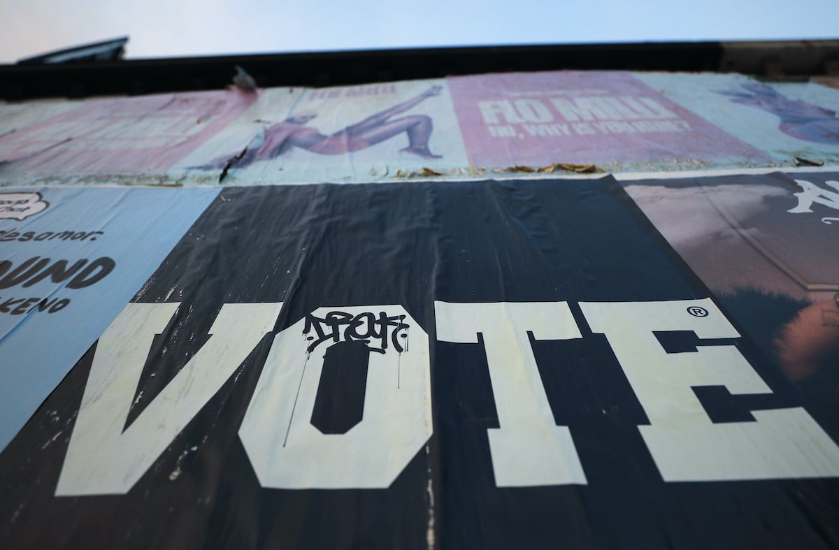 A poster reads 'Vote'