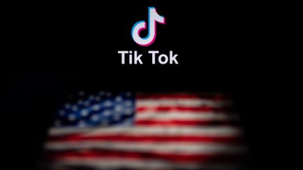 This photo illustration taken on September 14, 2020 shows the logo of the social network application TikTok (top) and a US flag (bottom) shown on the screens of two laptops in Beijing. - US tech giant Microsoft said on September 13 its offer to buy TikTok was rejected, leaving Oracle as the sole remaining bidder ahead of the imminent deadline for the Chinese-owned video app to sell or shut down its US operations. (Photo by NICOLAS ASFOURI / AFP) (Photo by NICOLAS ASFOURI/AFP via Getty Images)