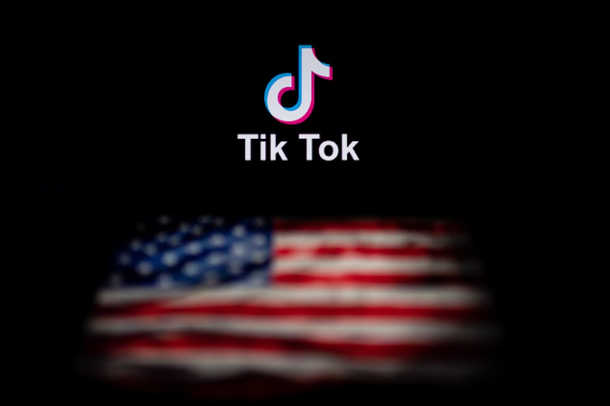 This photo illustration taken on September 14, 2020 shows the logo of the social network application TikTok (top) and a US flag (bottom) shown on the screens of two laptops in Beijing. - US tech giant Microsoft said on September 13 its offer to buy TikTok was rejected, leaving Oracle as the sole remaining bidder ahead of the imminent deadline for the Chinese-owned video app to sell or shut down its US operations. (Photo by NICOLAS ASFOURI / AFP) (Photo by NICOLAS ASFOURI/AFP via Getty Images)