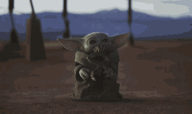 Baby Yoda eats a space frog.