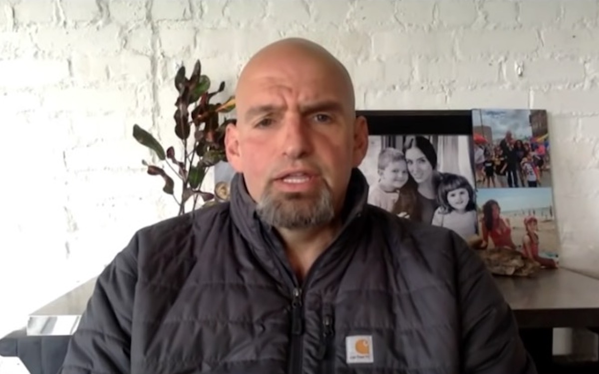 John Fetterman appears on MSNBC in front of pictures of his family.
