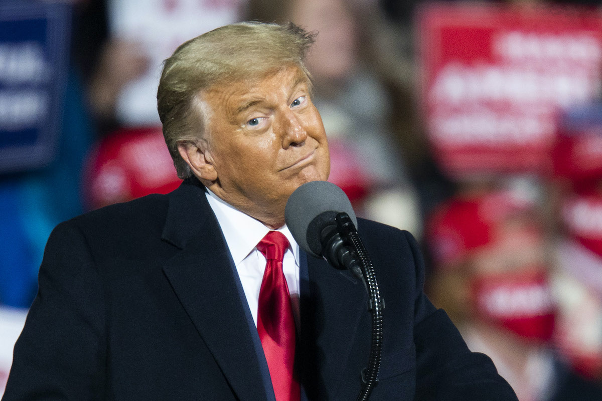Donald Trump smirks during a rally.