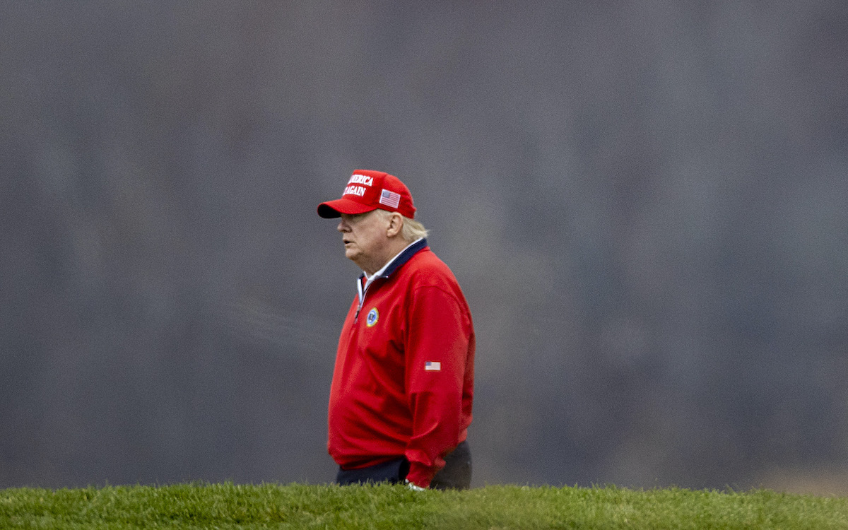 Donald Trump looks sad while playing golf.