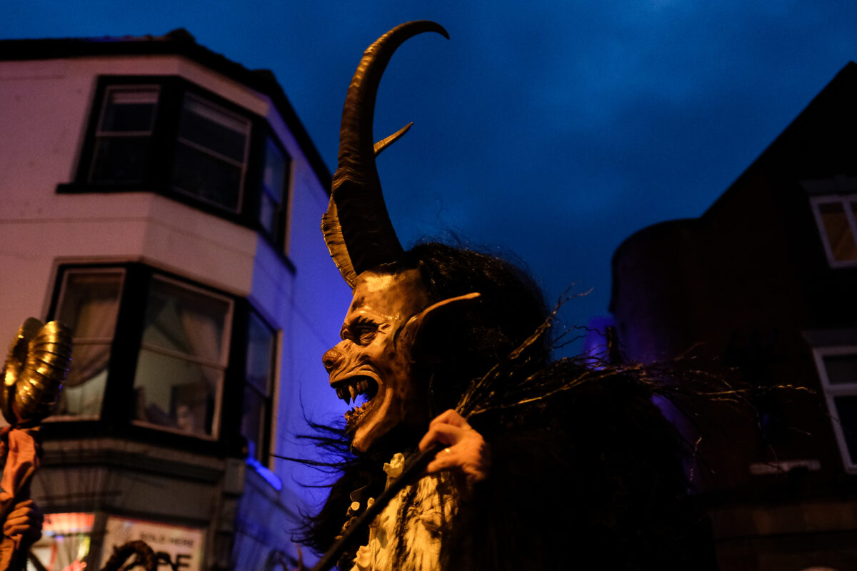 WHITBY, ENGLAND - DECEMBER 07: Participants walk through the streets during the annual Whitby Krampus parade on December 07, 2019 in Whitby, England. The Krampus is a horned, anthropomorphic figure from Austro-Bavarian Alpine folklore who during the Christmas season punished children who had misbehaved. The event held in Whitby helps to raise money for the Whitby Wildlife Sanctuary charity. (Photo by Ian Forsyth/Getty Images)