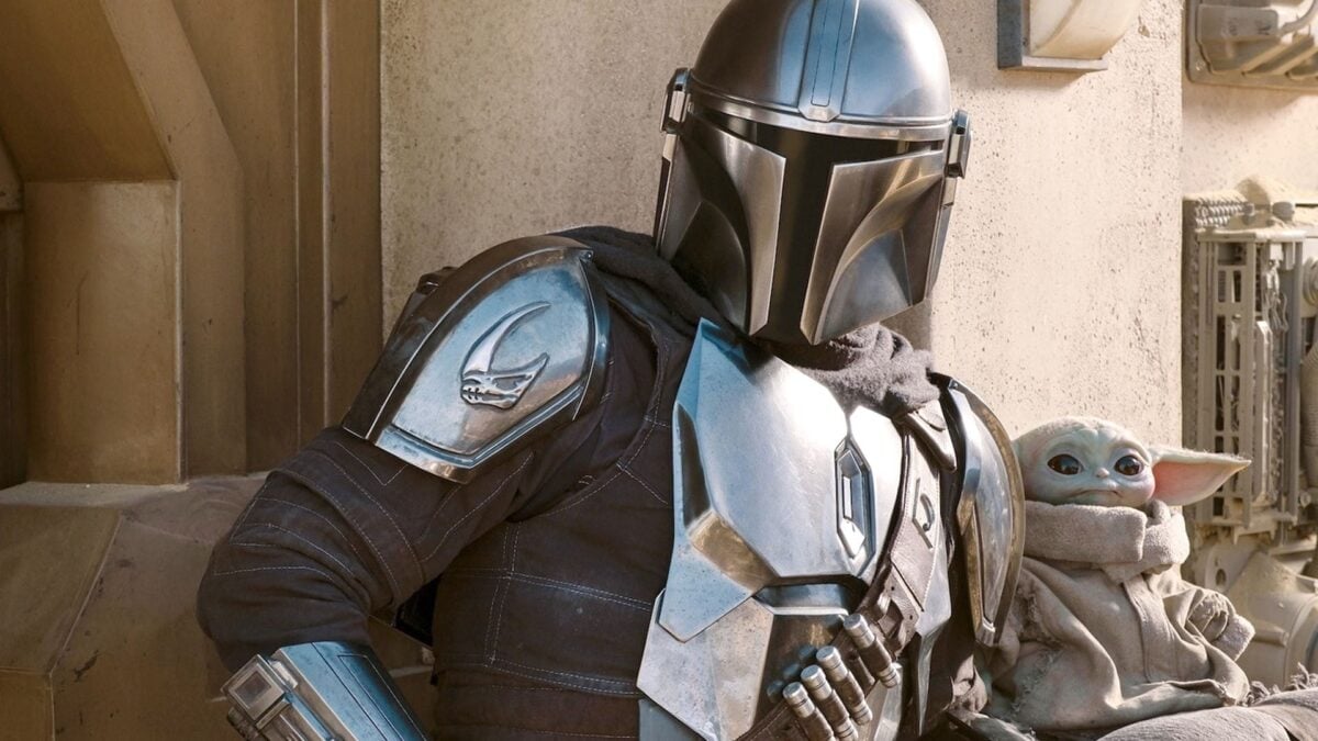 A man and his son (Din Djarin and Grogu) hanging out, on Disney+'s The Mandalorian Star Wars series.