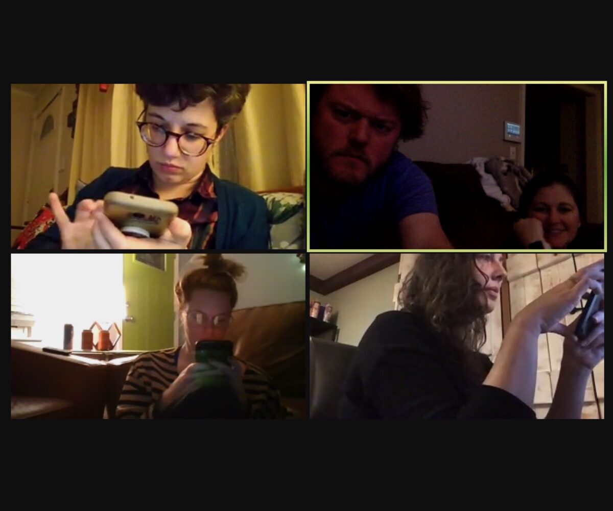 People look at their phones while on a video call.
