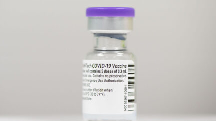 Closeup of a vial of COVID-19 vaccine.
