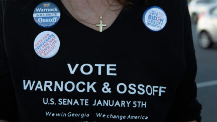 A supporter wears a homemade T-shirt to promote Democratic U.S. Senate candidates Jon Ossoff and Raphael Warnock of Georgia