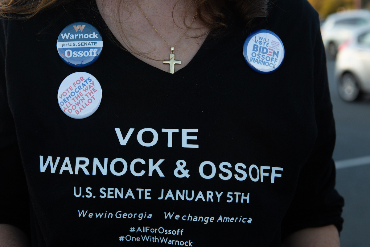 A supporter wears a homemade T-shirt to promote Democratic U.S. Senate candidates Jon Ossoff and Raphael Warnock of Georgia