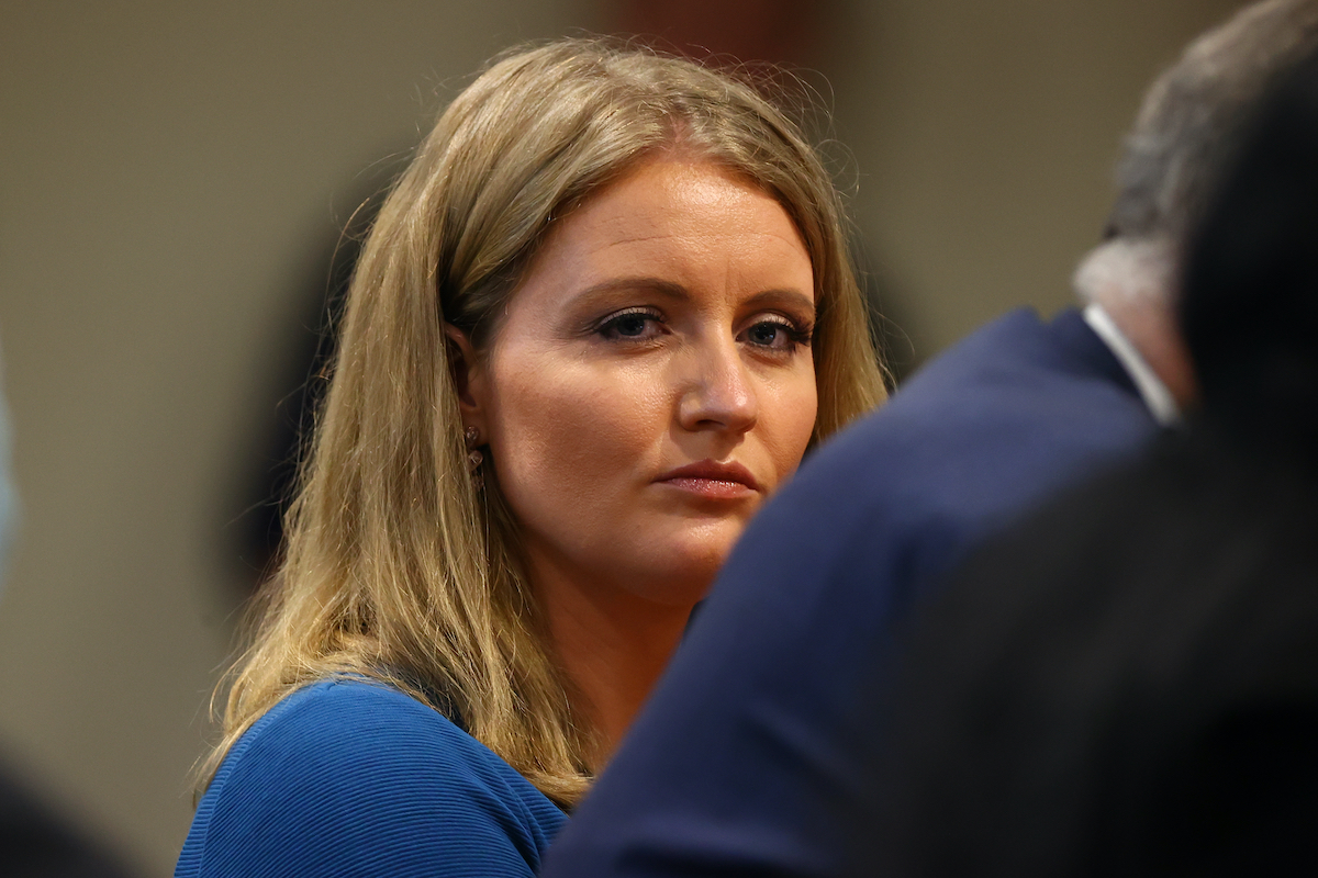 Jenna Ellis, a member of U.S. President Donald Trump's legal team, listens to Detroit poll worker Jessi Jacobs during an appearance before the Michigan House Oversight Committee