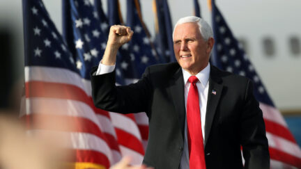Mike Pence fist pumps at a rally.