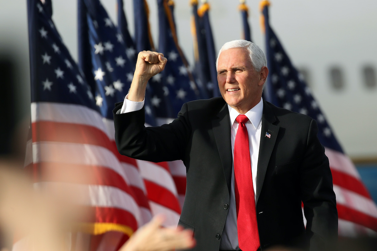 Mike Pence fist pumps at a rally.