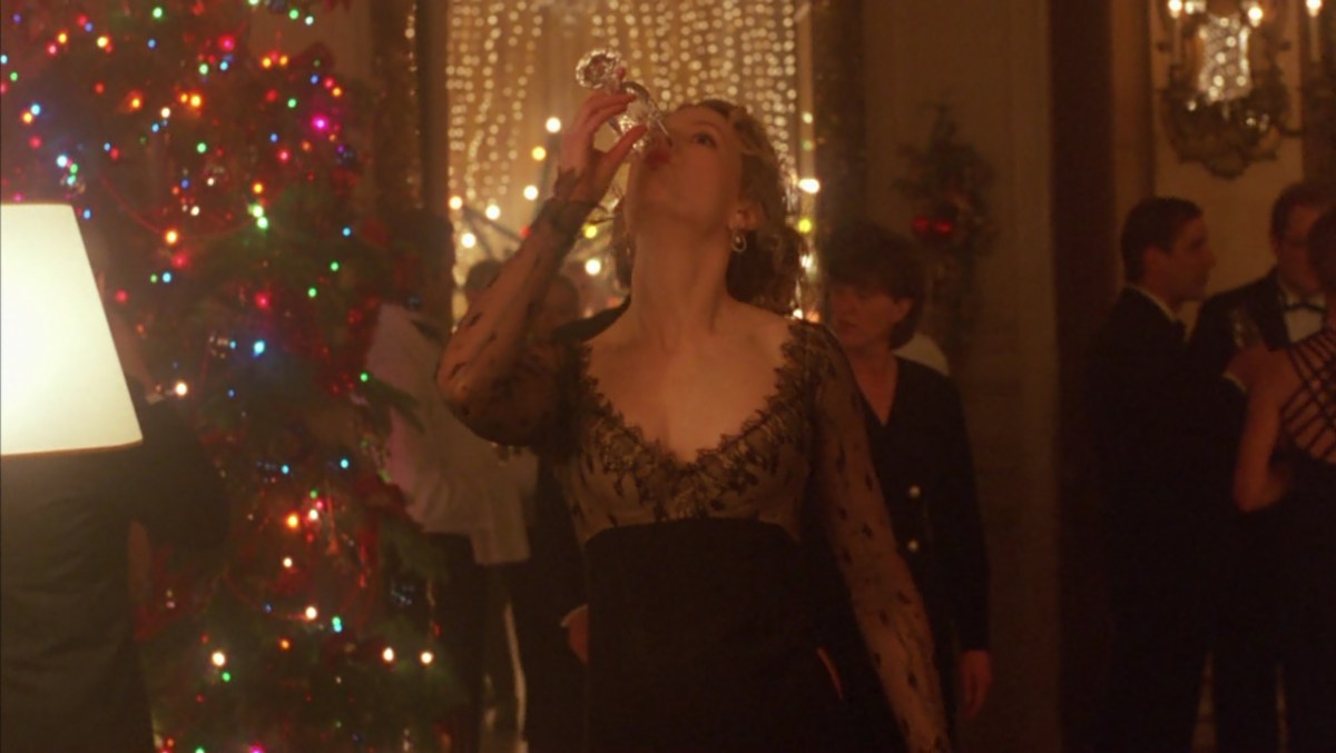 Nicole Kidman drinks champagne at a Christmas party in Eyes Wide Shut