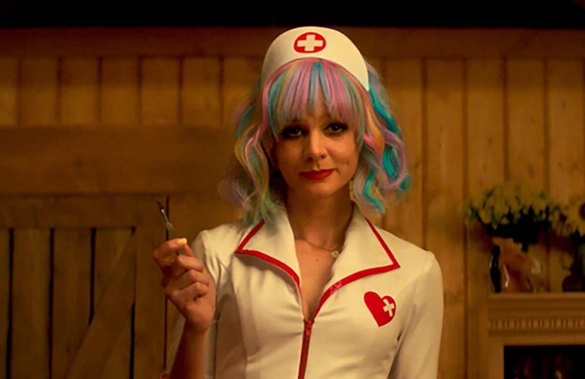 Cassie dressed as a nurse, holding up a scalpel in Promising Young Woman.