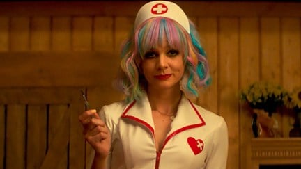 Cassie dressed as a nurse, holding up a scalpel in Promising Young Woman.
