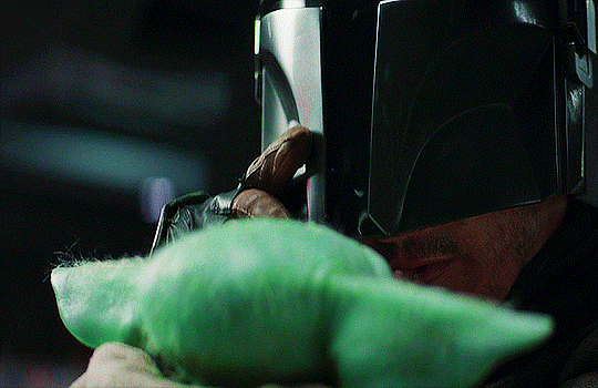 pedro pascal showing grogu his face