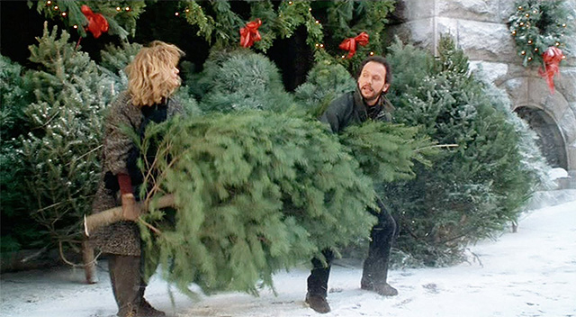 Meg Ryan and Billy Crystal carry a large Christmas Tree in When Harry Met Sally.