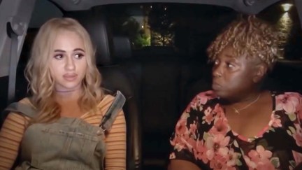 Maria Bakalova as Tutar in Borat 2 sits in a car with Jeanise Jones.