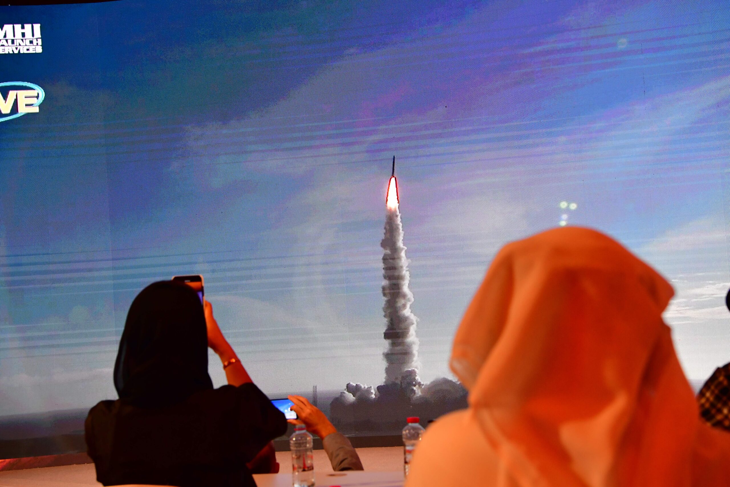 A picture taken on July 19, 2020, shows a screen broadcasting the launch of the "Hope" Mars probe at the Mohammed Bin Rashid Space Centre in Dubai. - The probe is one of three racing to the Red Planet, with Chinese and US rockets also taking advantage of the Earth and Mars being unusually close: a mere hop of 55 million kilometres (34 million miles). "Hope" -- Al-Amal in Arabic -- is expected to start orbiting Mars by February 2021, marking the 50th anniversary of the unification of the UAE. (Photo by Giuseppe CACACE / AFP) (Photo by GIUSEPPE CACACE/AFP via Getty Images)