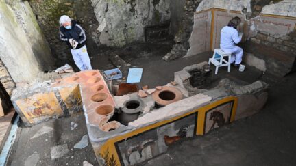 Restorers work in the new area of the 'Thermopolium' at the archaeological site of Pompeii, near Naples, on January 25, 2021. - The 'Thermopolium' used to offer a quick midday meal with hot food and drinks to the Romans away from home. (Photo by Andreas SOLARO / AFP) (Photo by ANDREAS SOLARO/AFP via Getty Images)