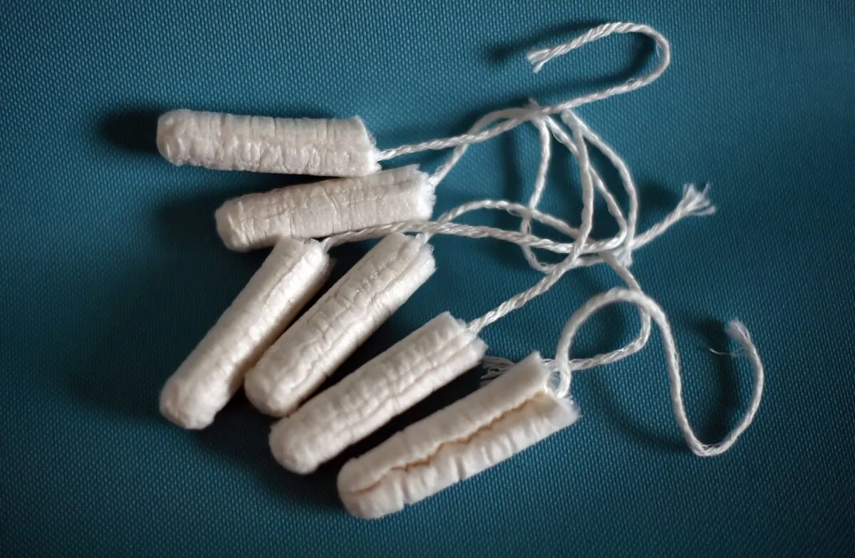 six tampons against a blue background