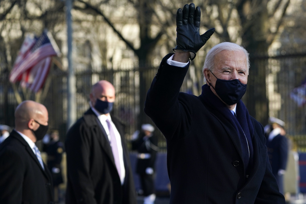 Joe Biden waves while walking the inaugural parade route.