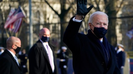 Joe Biden waves while walking the inaugural parade route.