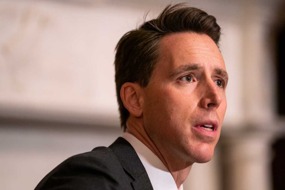 Josh Hawley looks on with his stupid face.