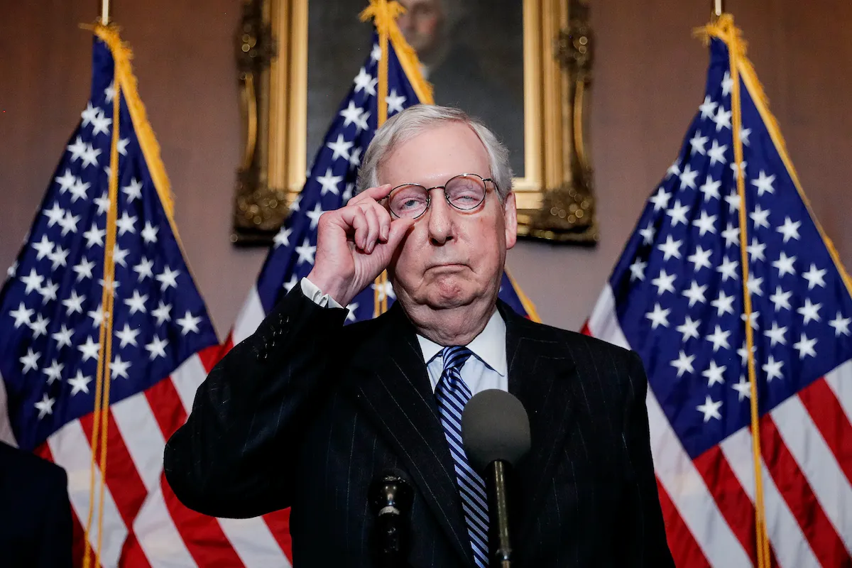 Mitch McConnell looks like his face is falling apart during a press conference.