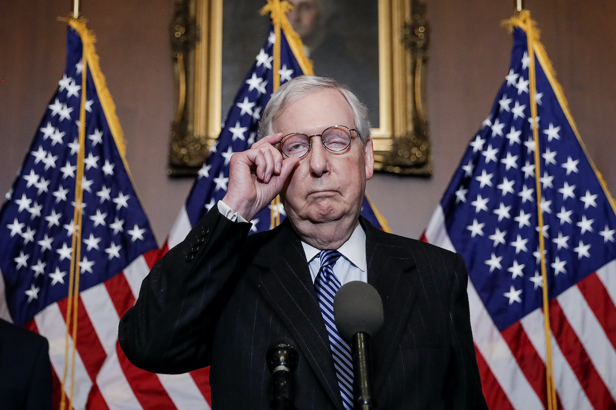 Mitch McConnell looks like his face is falling apart during a press conference.