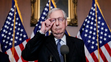 Mitch McConnell looks like his face is falling apart during a press conference.