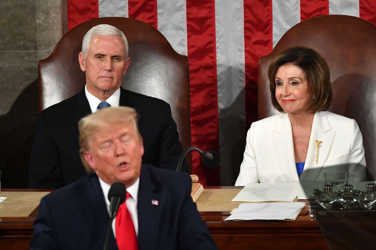 Nancy Pelosi sits next to Mike Pence, wearing her mace brooch while watching Trump give the state of the union address.
