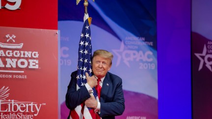 Donald Trump proves how much he loves America by hugging a flag and smirking